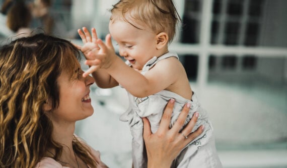 new mother holding a toddler